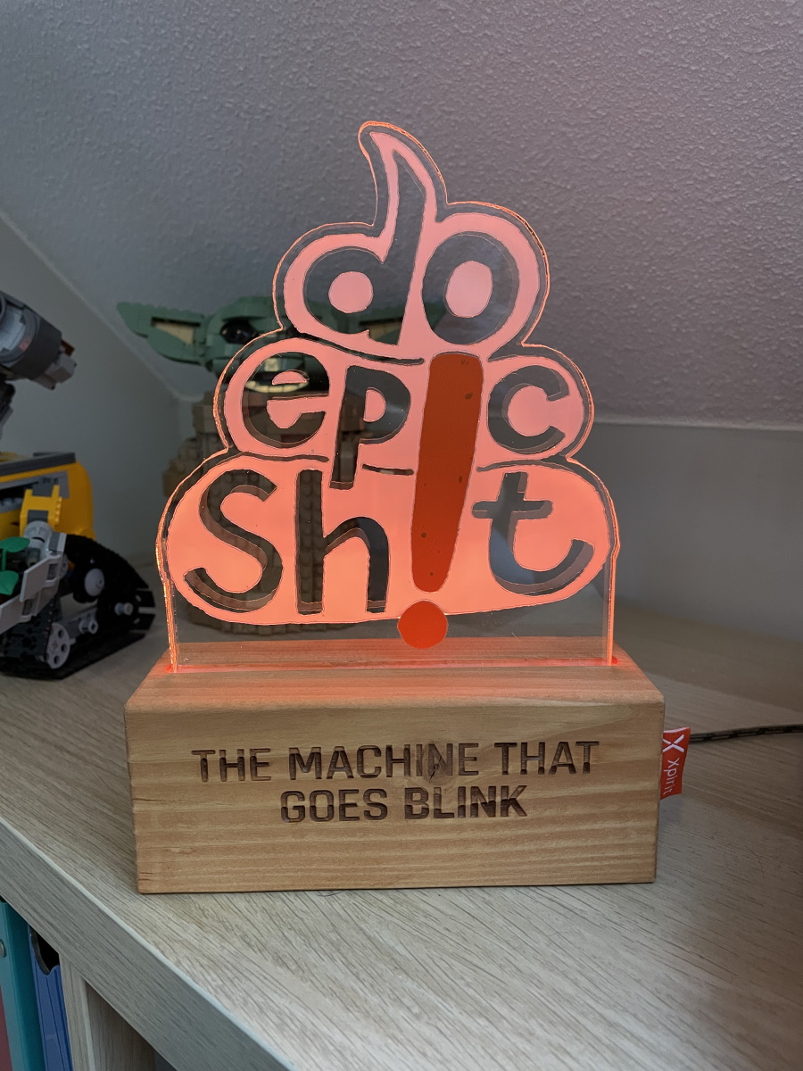 Photo of the Do Epic Shit signal: a light in the form of a turd that spells out the words 'Do epic shit'