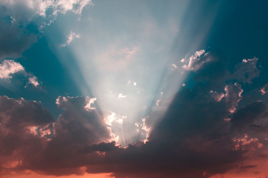 Photo of a ray of sun in between the clouds