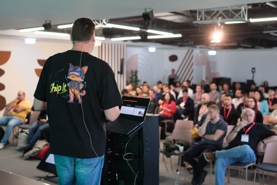 Photo of Rob on the stage, showing the full room